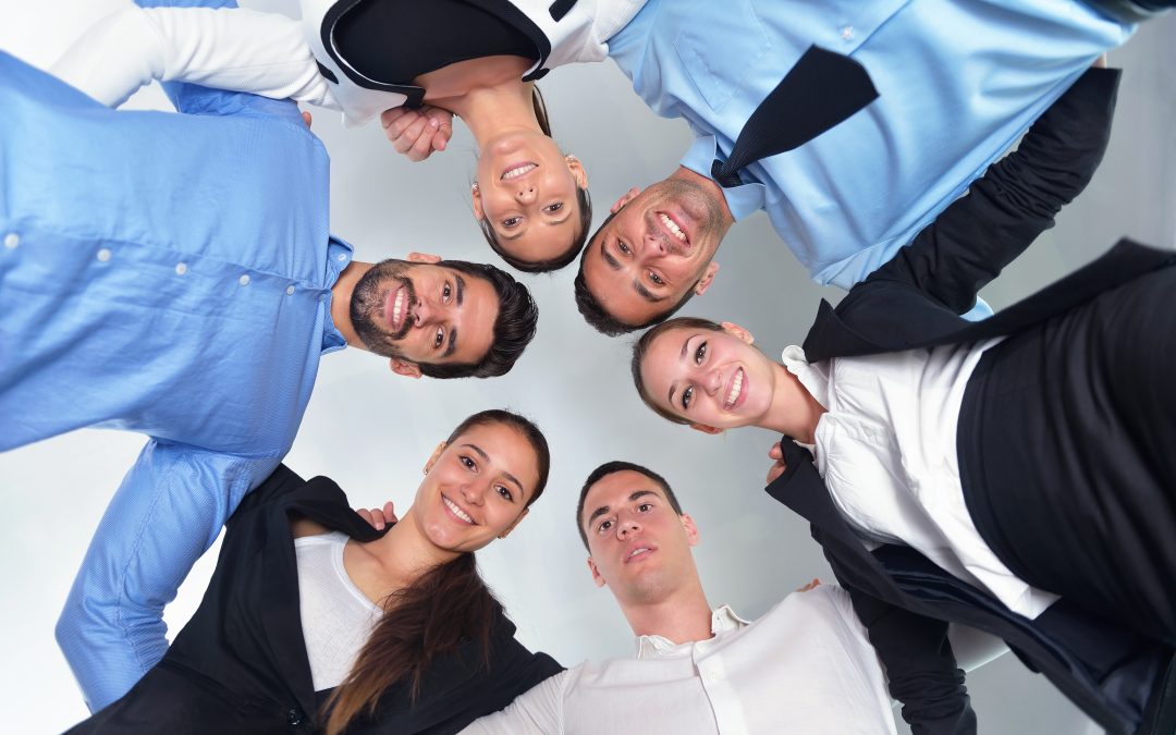 Group of happy young business people in a meeting at office