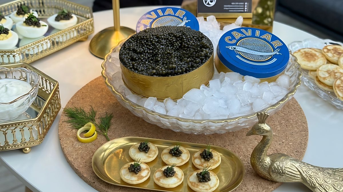 Caviar tins on ice with blinis and deviled eggs at a One Sushi caviar bar