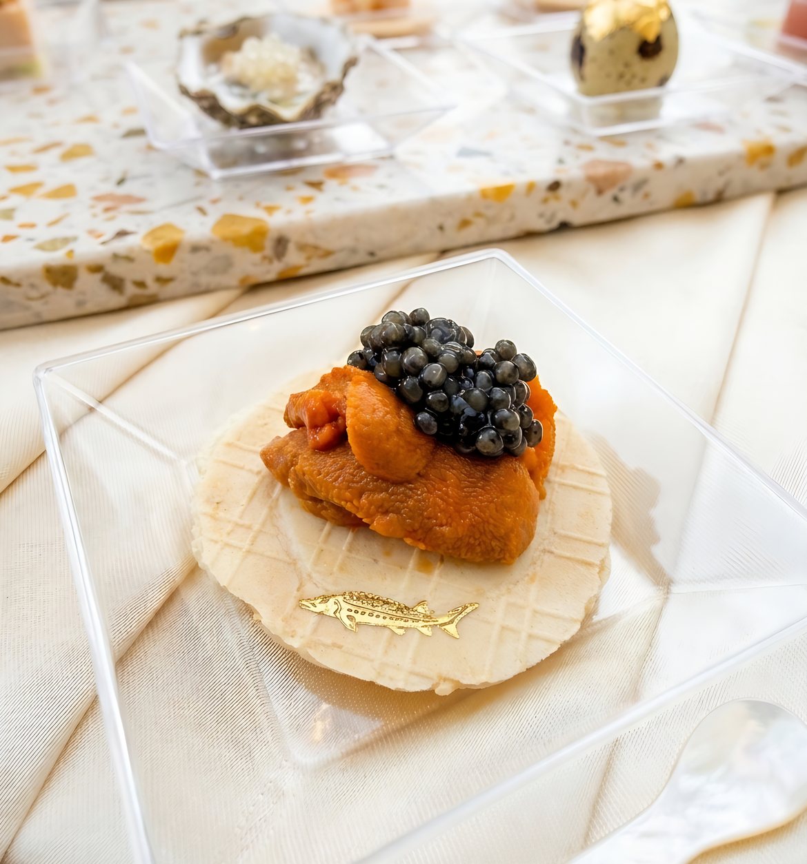 Uni and caviar bite on a wafer served by One Sushi